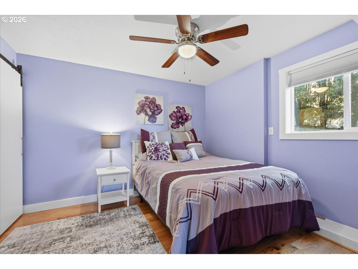 10339 Southwest 40th Avenue Portland, OR 97219 - Photo 25 of 37 a bedroom with a bed and a painting on the wall