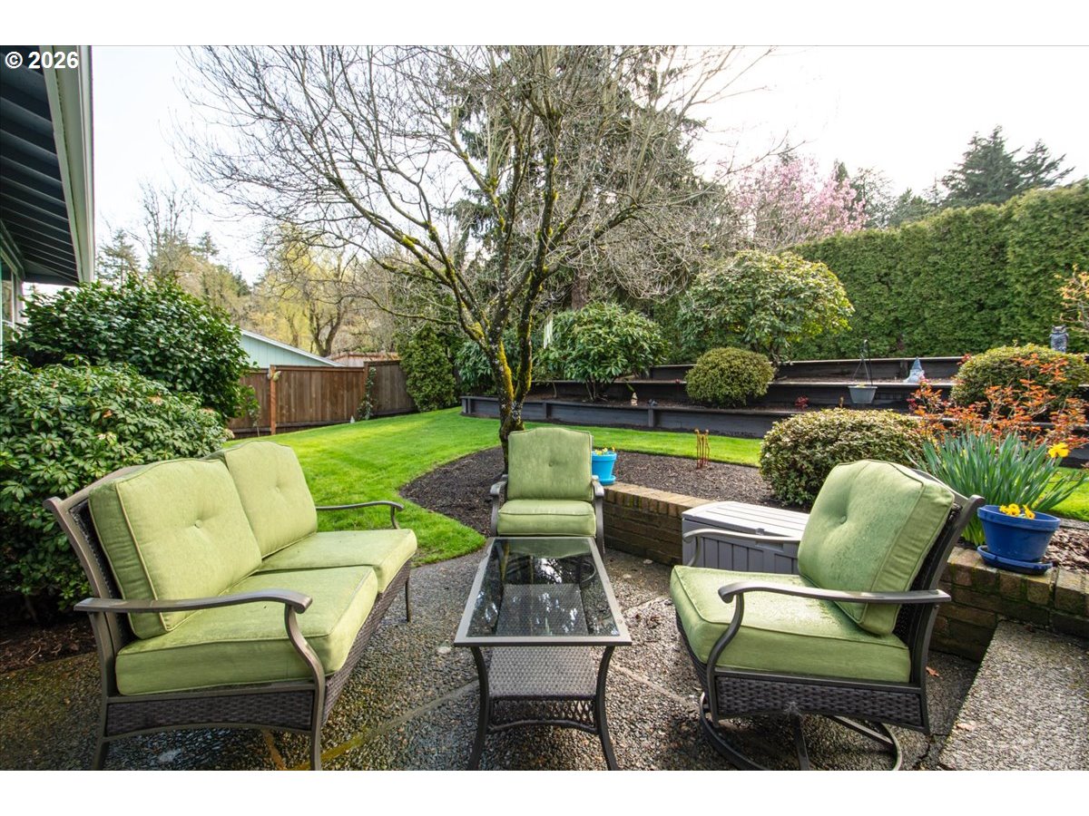 10339 Southwest 40th Avenue Portland, OR 97219 - Photo 28 of 37 a backyard of a house with table and chairs