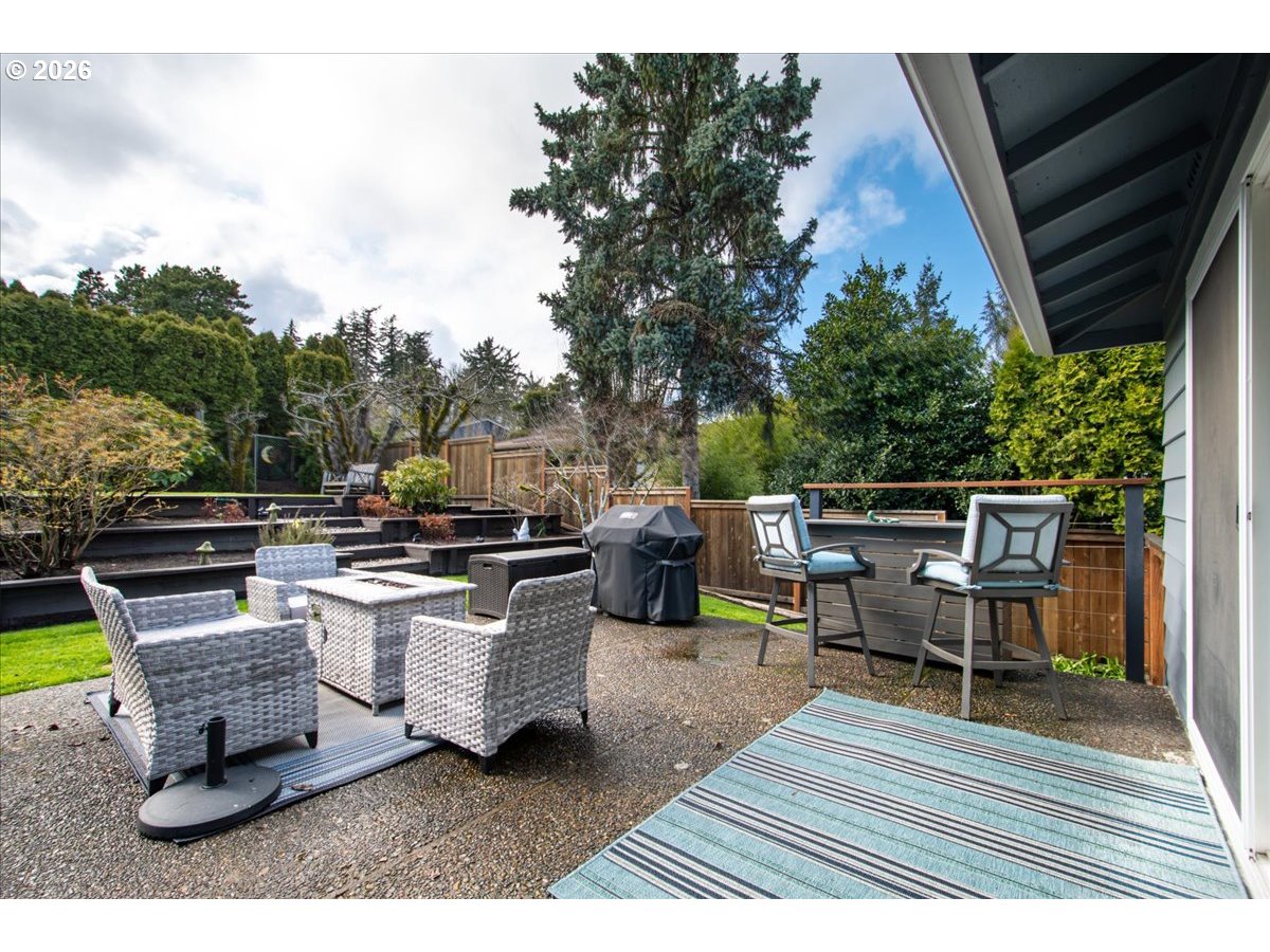 10339 Southwest 40th Avenue Portland, OR 97219 - Photo 29 of 37 a view of a roof deck with table and chairs couches with wooden floor and fence
