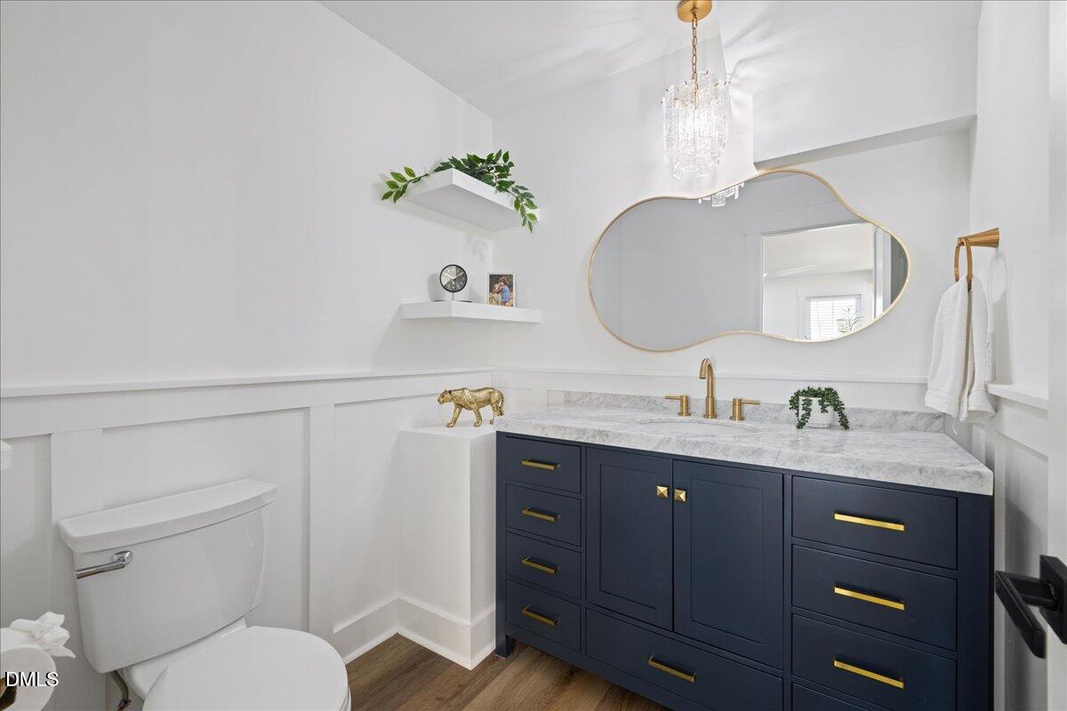 617 North 3rd Street Mebane, NC 27302 - Photo 25 of 50 a bathroom with a granite countertop toilet sink and mirror