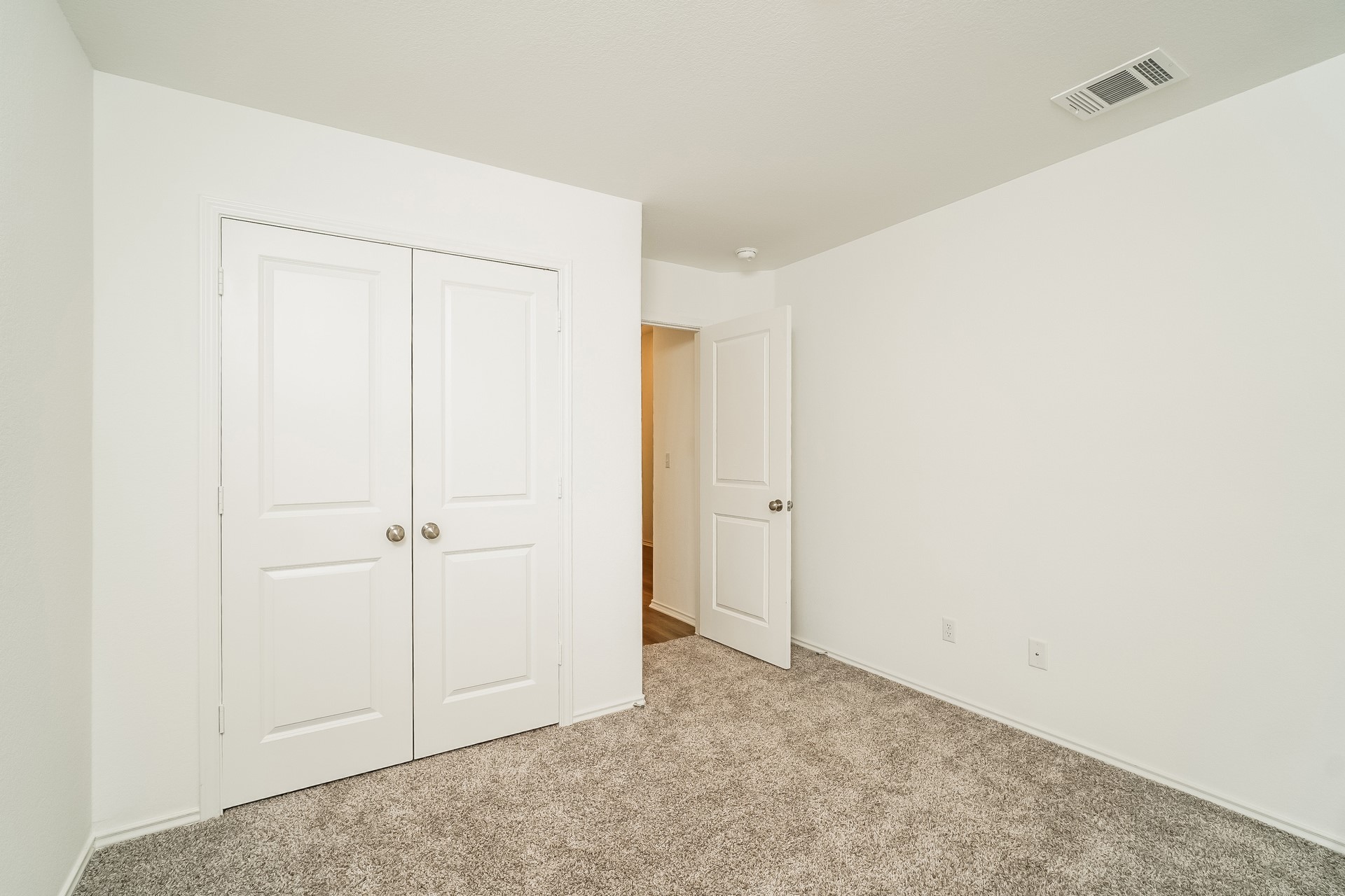 341 Madrid Kyle, TX 78640 - Photo 18 of 27 A spacious chamber with soft carpeting, ready for personalized touches.