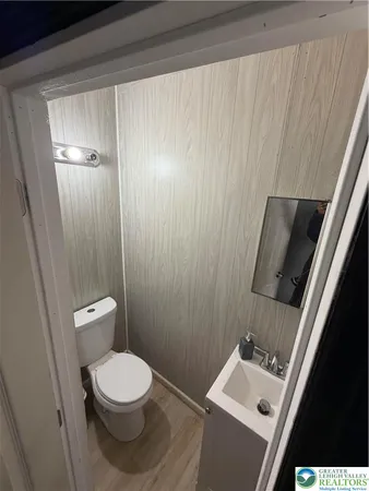 a bathroom with a toilet a sink and mirror