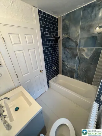 a bathroom with a bathtub and shower