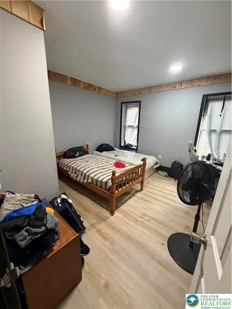a bedroom with a bed and a mirror