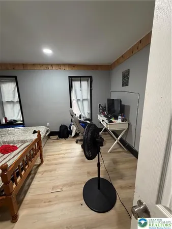 a bedroom with furniture and a window