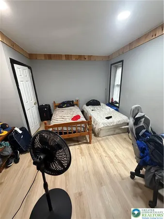 a living room with furniture and a dresser