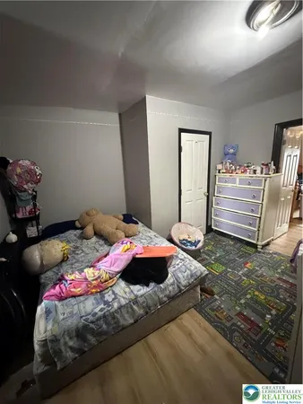 a bedroom with a bed and a table in it