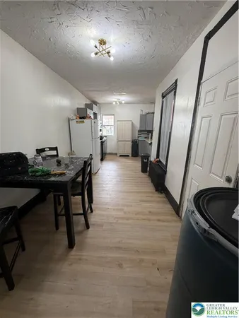 a view of a room with furniture and wooden floor