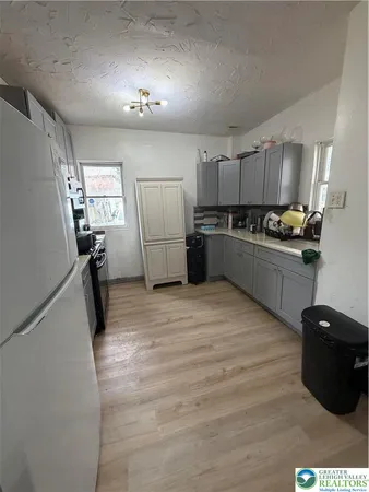 a kitchen with granite countertop a refrigerator stove and microwave