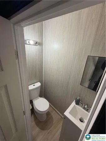 a white toilet sitting next to a small sink
