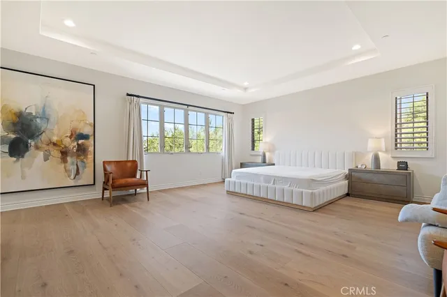 a spacious bedroom with a large bed and a couch