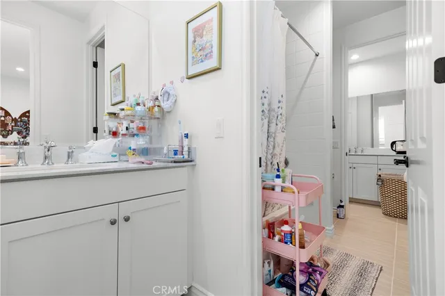 a bathroom with a sink mirror and vanity