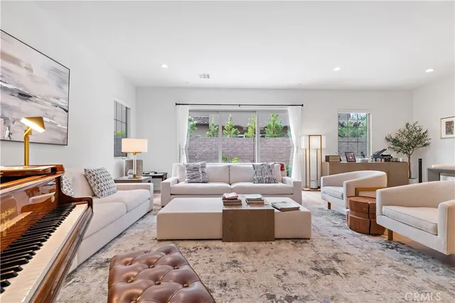 a large bedroom with furniture and a large window