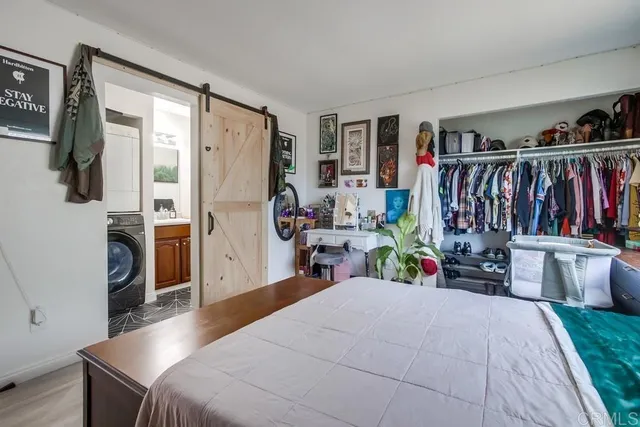 a bedroom with bed and a window