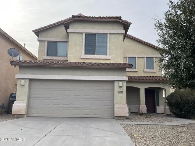a front view of a house with garage