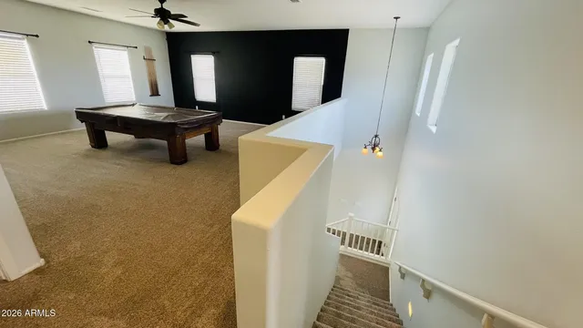 a room with pool table and windows