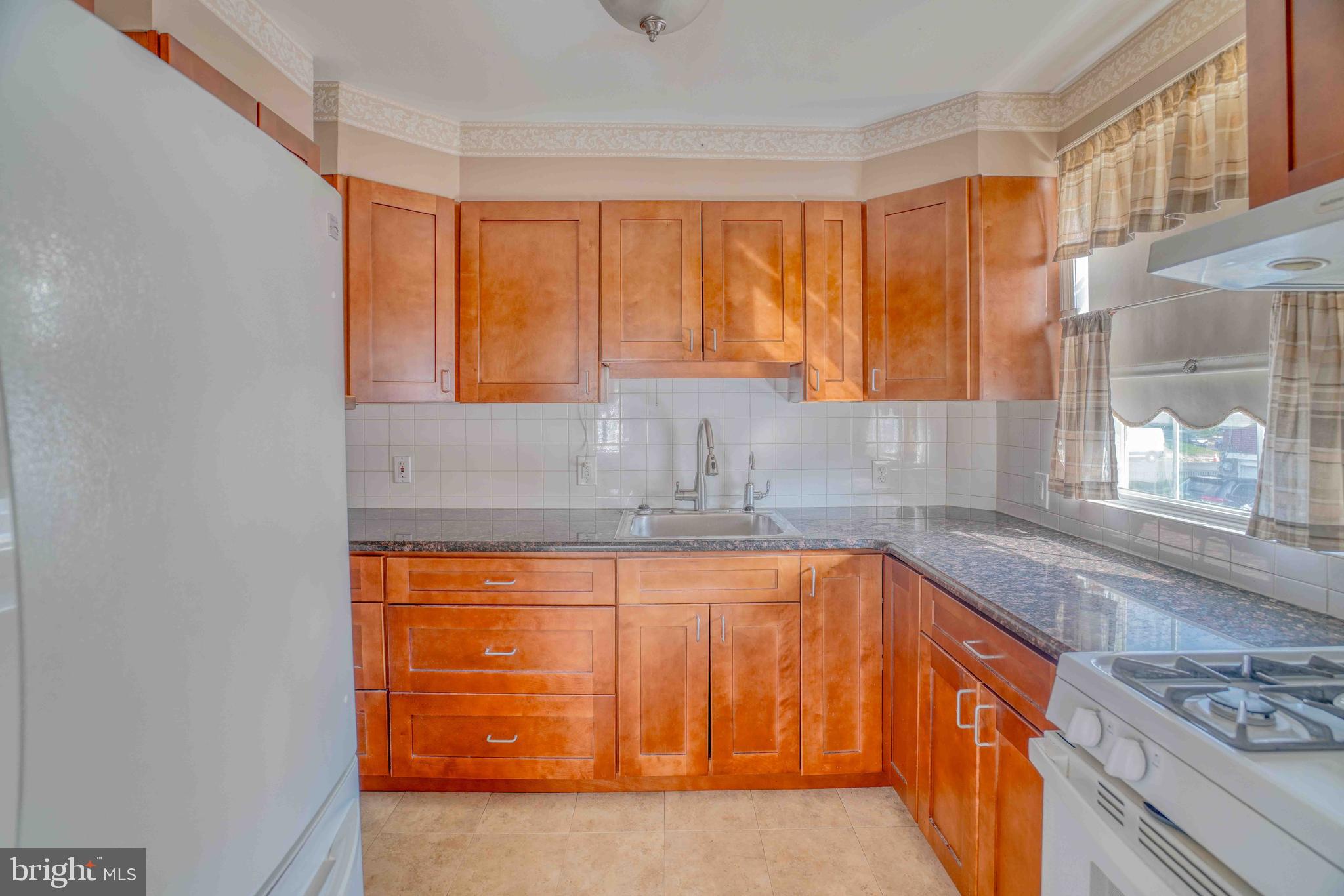1136 Kerper Street Philadelphia, PA 19111 - Photo 13 of 41 a kitchen with stainless steel appliances granite countertop a sink and a stove