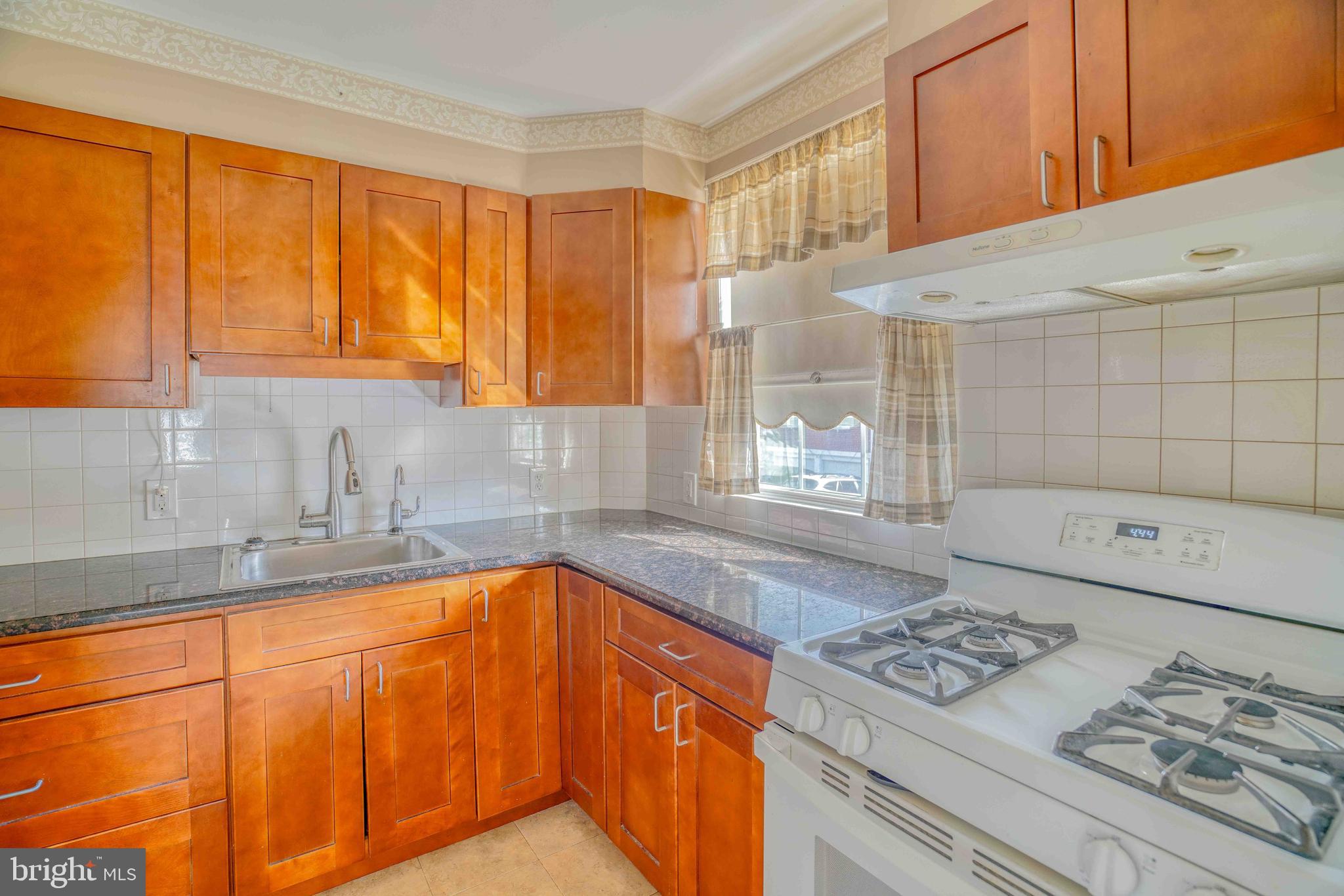 1136 Kerper Street Philadelphia, PA 19111 - Photo 14 of 41 a kitchen with stainless steel appliances granite countertop a sink stove and refrigerator