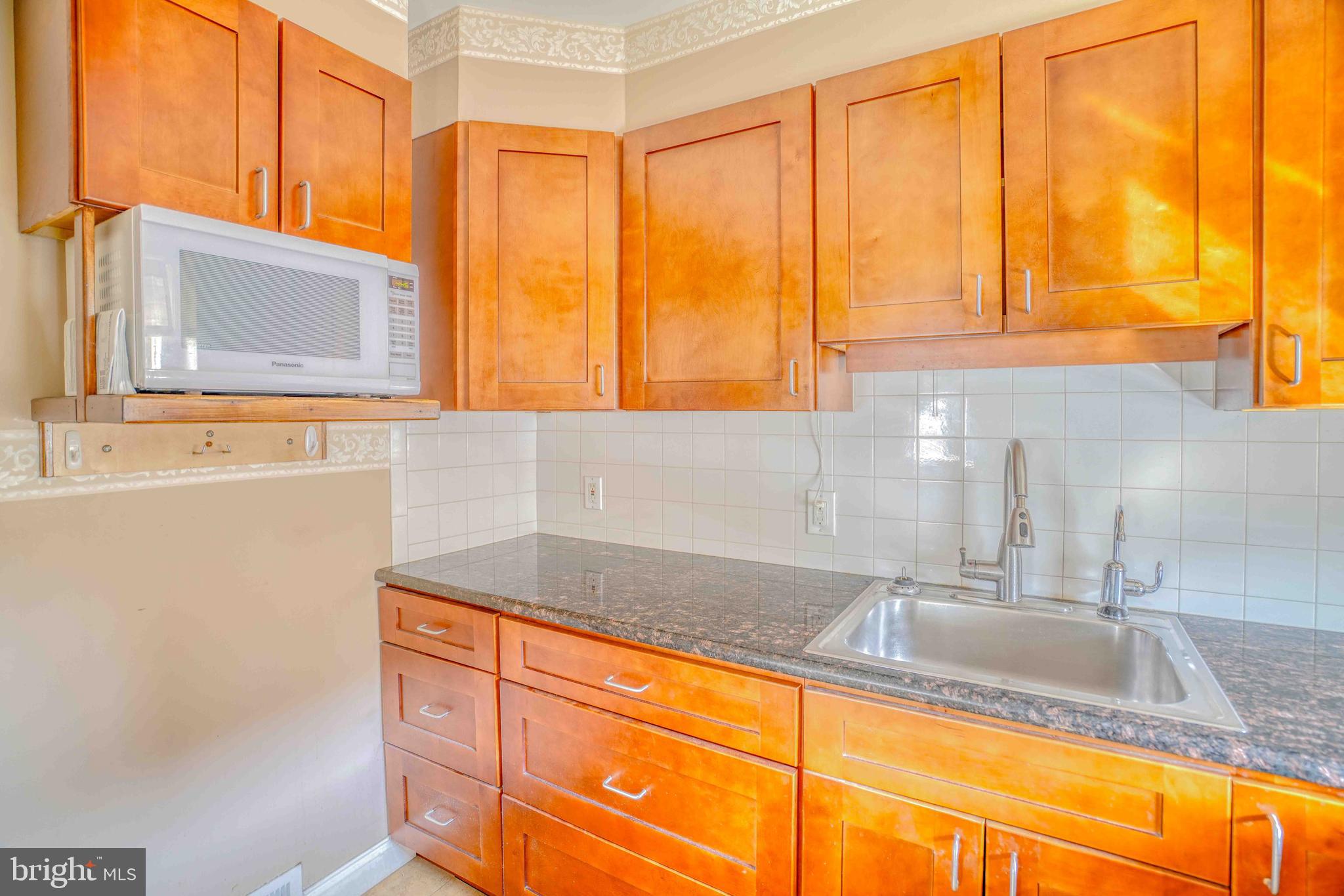 1136 Kerper Street Philadelphia, PA 19111 - Photo 15 of 41 a kitchen with stainless steel appliances granite countertop a sink and a window