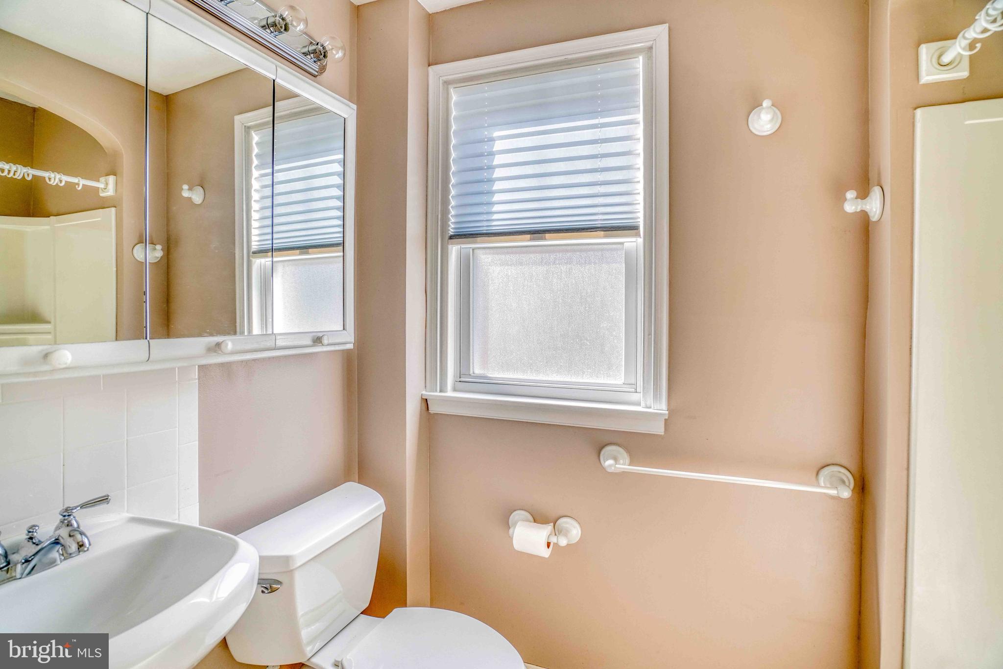 1136 Kerper Street Philadelphia, PA 19111 - Photo 21 of 41 a bathroom with a toilet sink and mirror