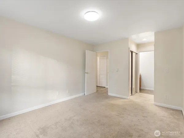 a view of an empty room and a window