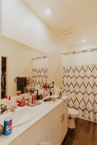 a bathroom with a sink and a mirror with shower curtain