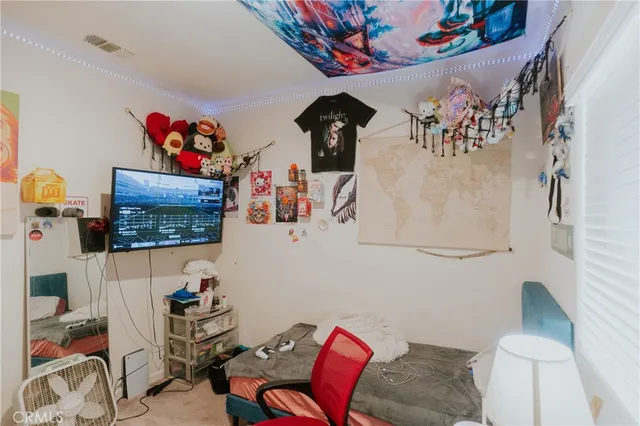 wooden floor and closet area with rug