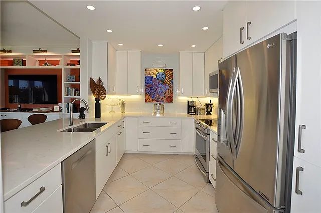 a kitchen with refrigerator and cabinets