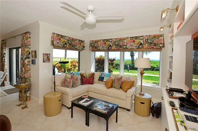 a living room with furniture and a floor to ceiling window
