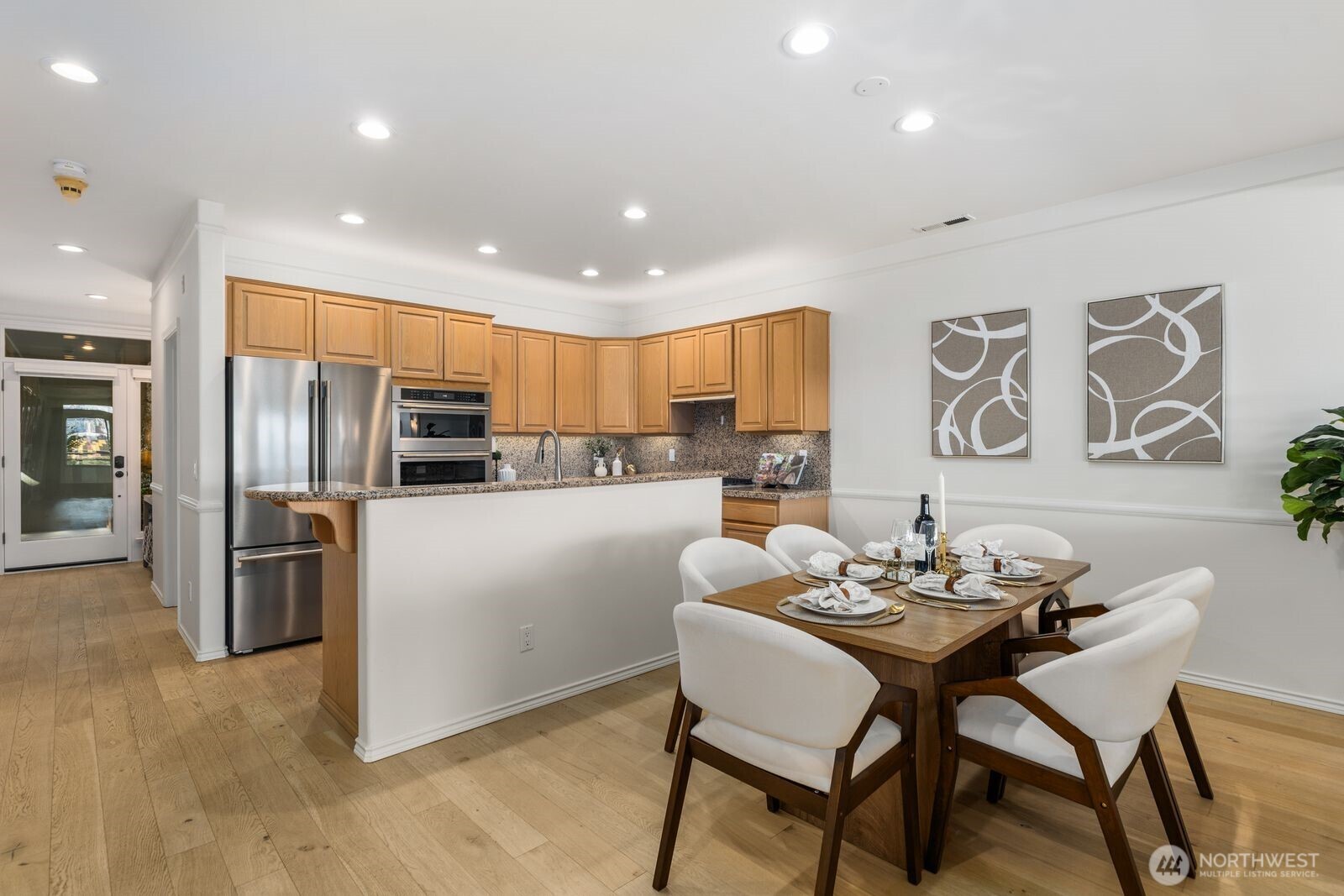 2349 Harbor Avenue Southwest, Unit 701 Seattle, WA 98126 - Photo 12 of 39 a kitchen with a refrigerator and a dining table