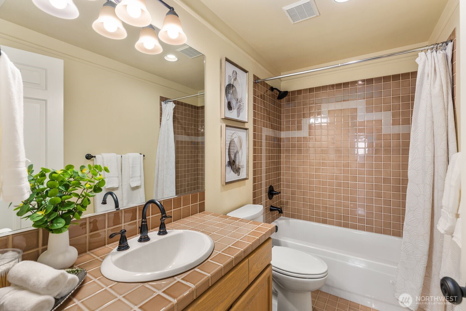 2349 Harbor Avenue Southwest, Unit 701 Seattle, WA 98126 - Photo 4 of 39 a bathroom with a sink toilet a mirror and shower