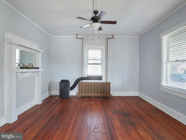 a workspace with wooden floor and windows