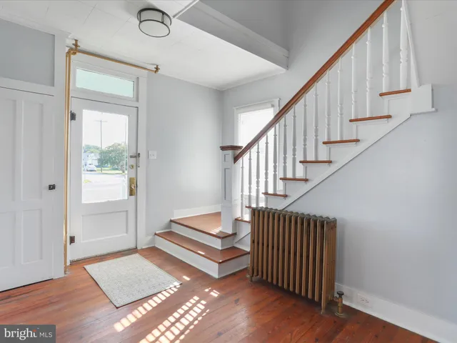 a view of staircase with white walls and a window