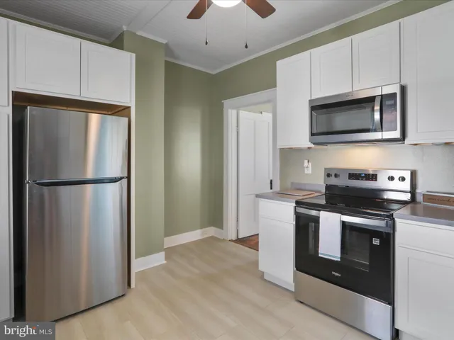 a kitchen with stainless steel appliances a refrigerator stove and microwave