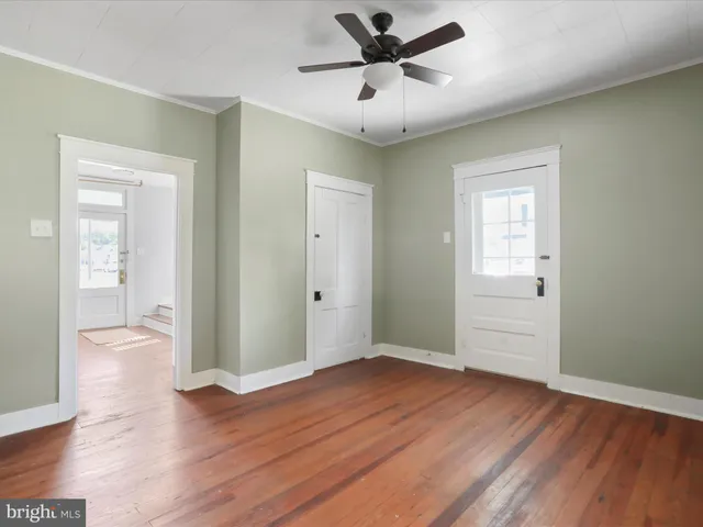 a view of an empty room and wooden floor