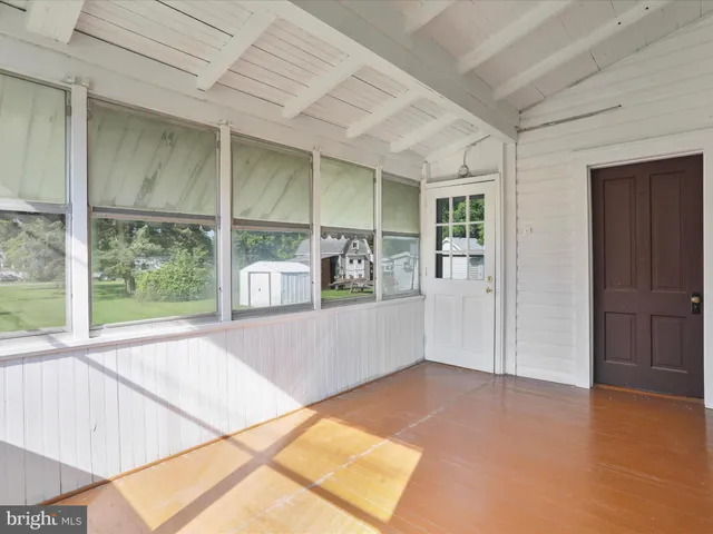a view of an empty room with window and cabinet