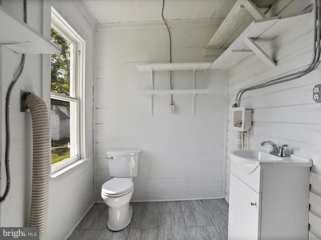 a bathroom with a toilet sink and a shower