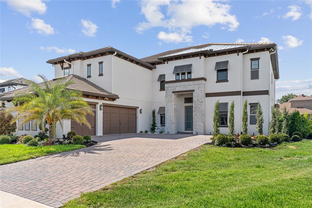 10175 Brocksport Circle Gotha, FL 34734 - Photo 1 of 54 a view of a white house next to a yard with potted plants