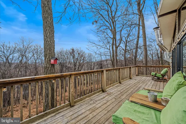 a view of balcony with wooden floor and outdoor seating