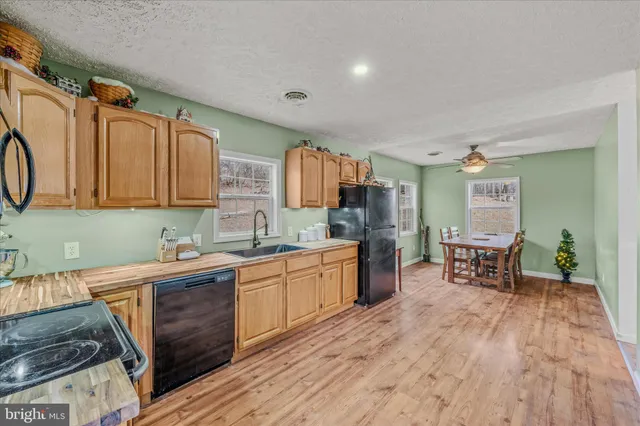 a kitchen with a sink cabinets and wooden floor