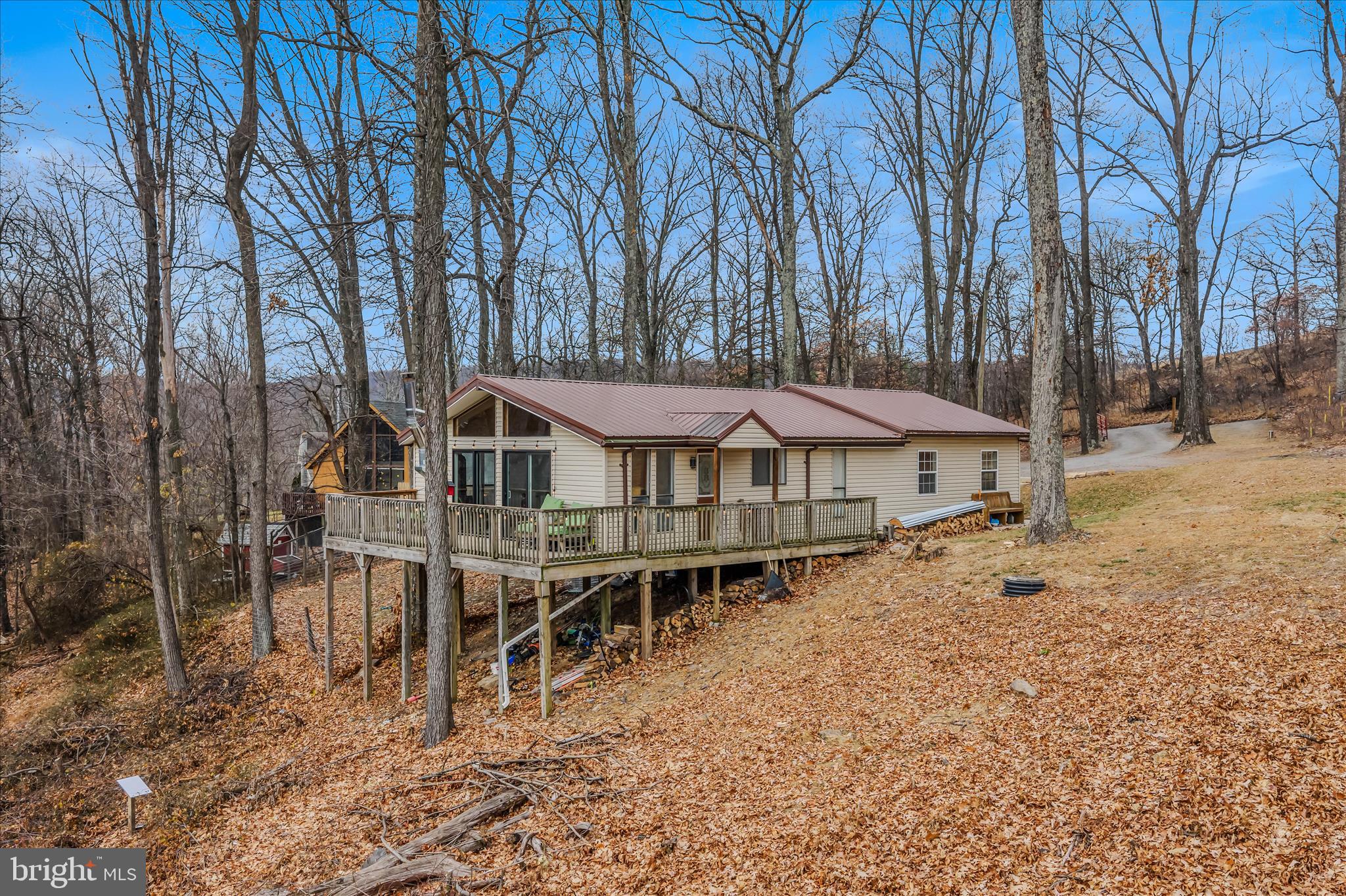 384 Trapper Ridge Lane Hedgesville, WV 25427 - Photo 2 of 52 a backyard of a house with table and chairs