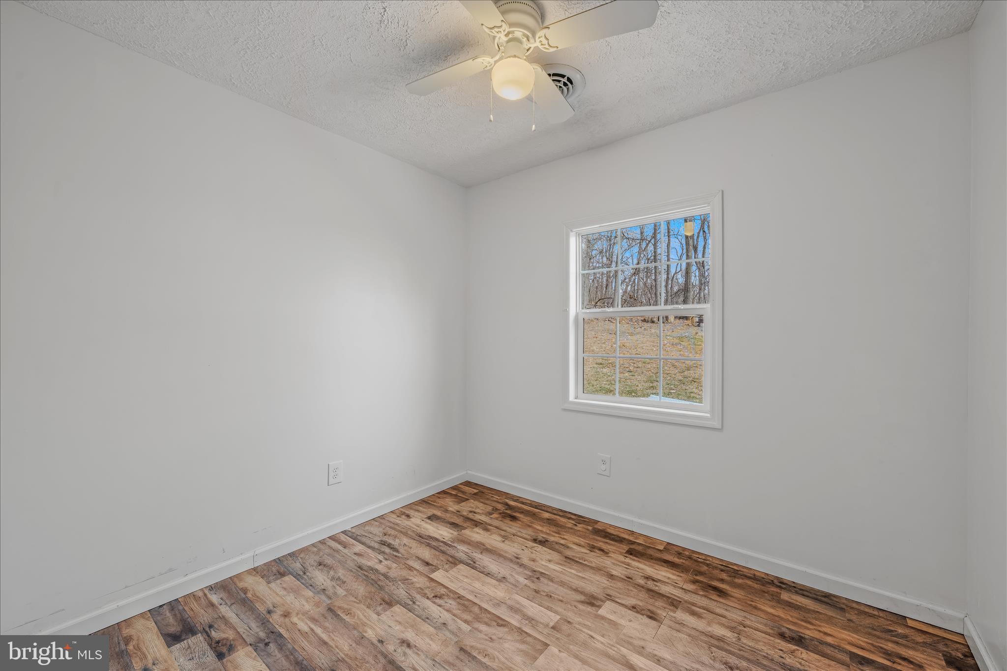 384 Trapper Ridge Lane Hedgesville, WV 25427 - Photo 25 of 52 an empty room with a window and a fan