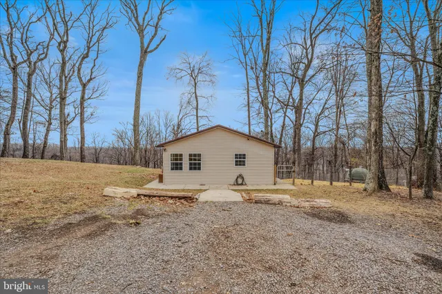 a white house that has a tree in front of it
