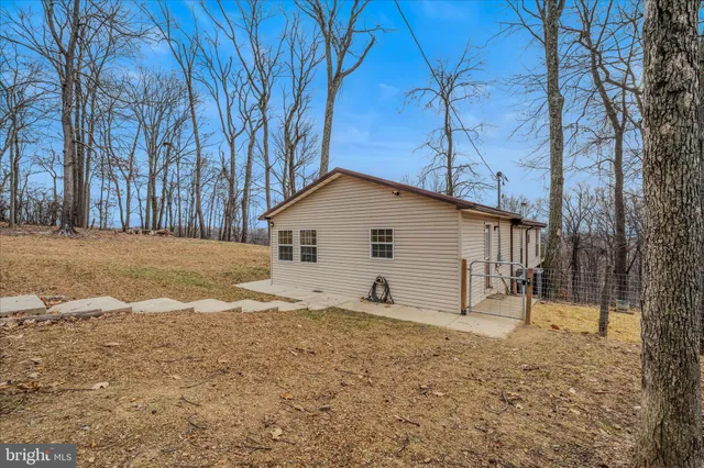 a view of a house with a yard covered with snow