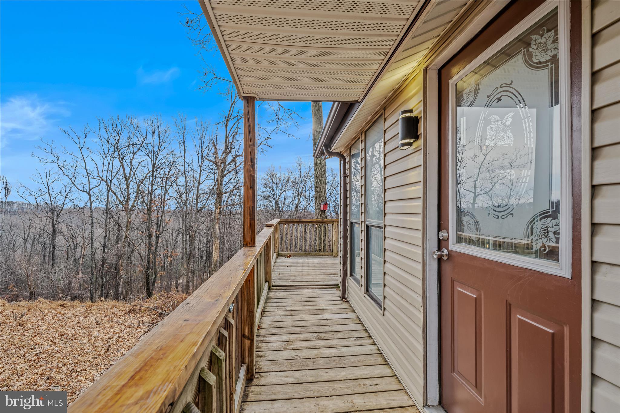 384 Trapper Ridge Lane Hedgesville, WV 25427 - Photo 4 of 52 a view of a balcony with wooden floor and stairs