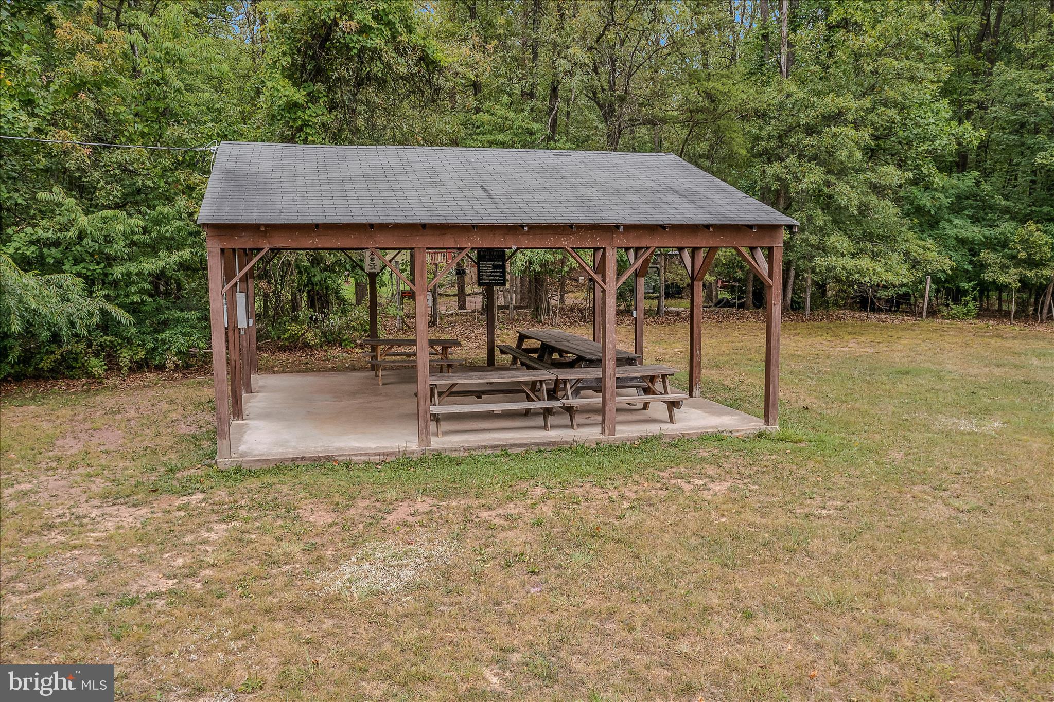384 Trapper Ridge Lane Hedgesville, WV 25427 - Photo 48 of 52 a backyard of a house with table and chairs