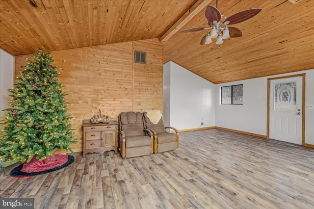a view of a backyard with chair and wooden floor