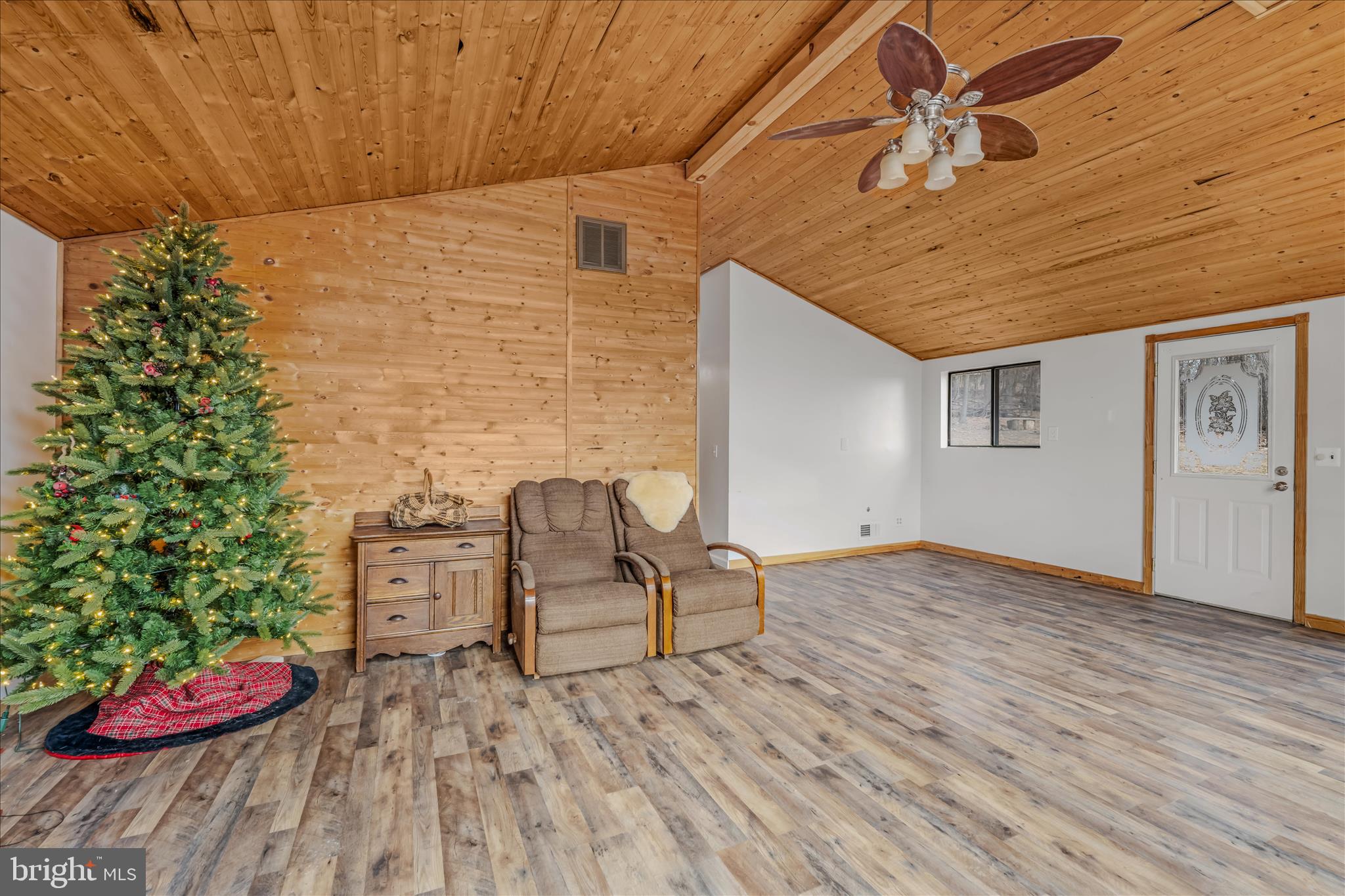 384 Trapper Ridge Lane Hedgesville, WV 25427 - Photo 8 of 52 a view of a backyard with chair and wooden floor