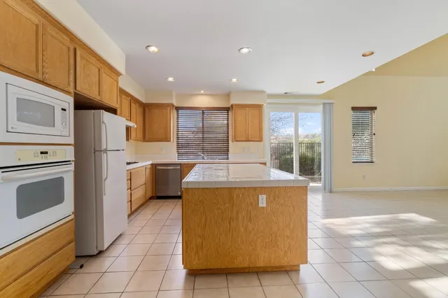 a kitchen with a stove a refrigerator and a sink