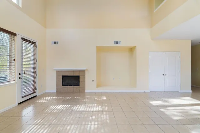 a view of a livingroom with a fireplace and window